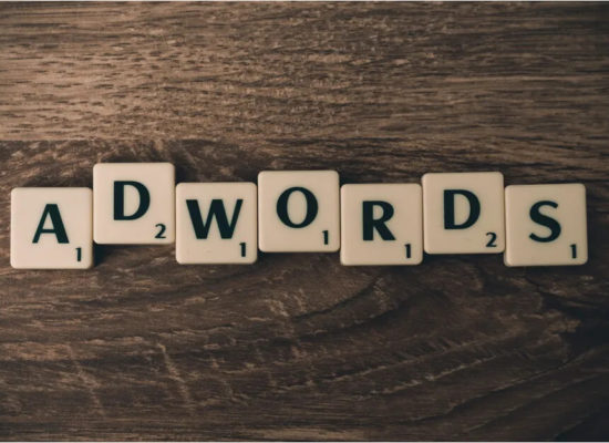 Adwords spelled out on a wooden desk